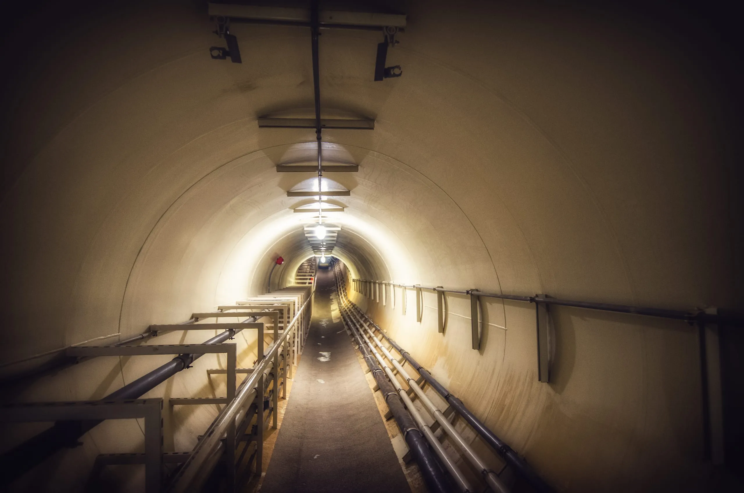 Service tunnel beneath Biosphere 2 lined with pipes and machinery, Arizona