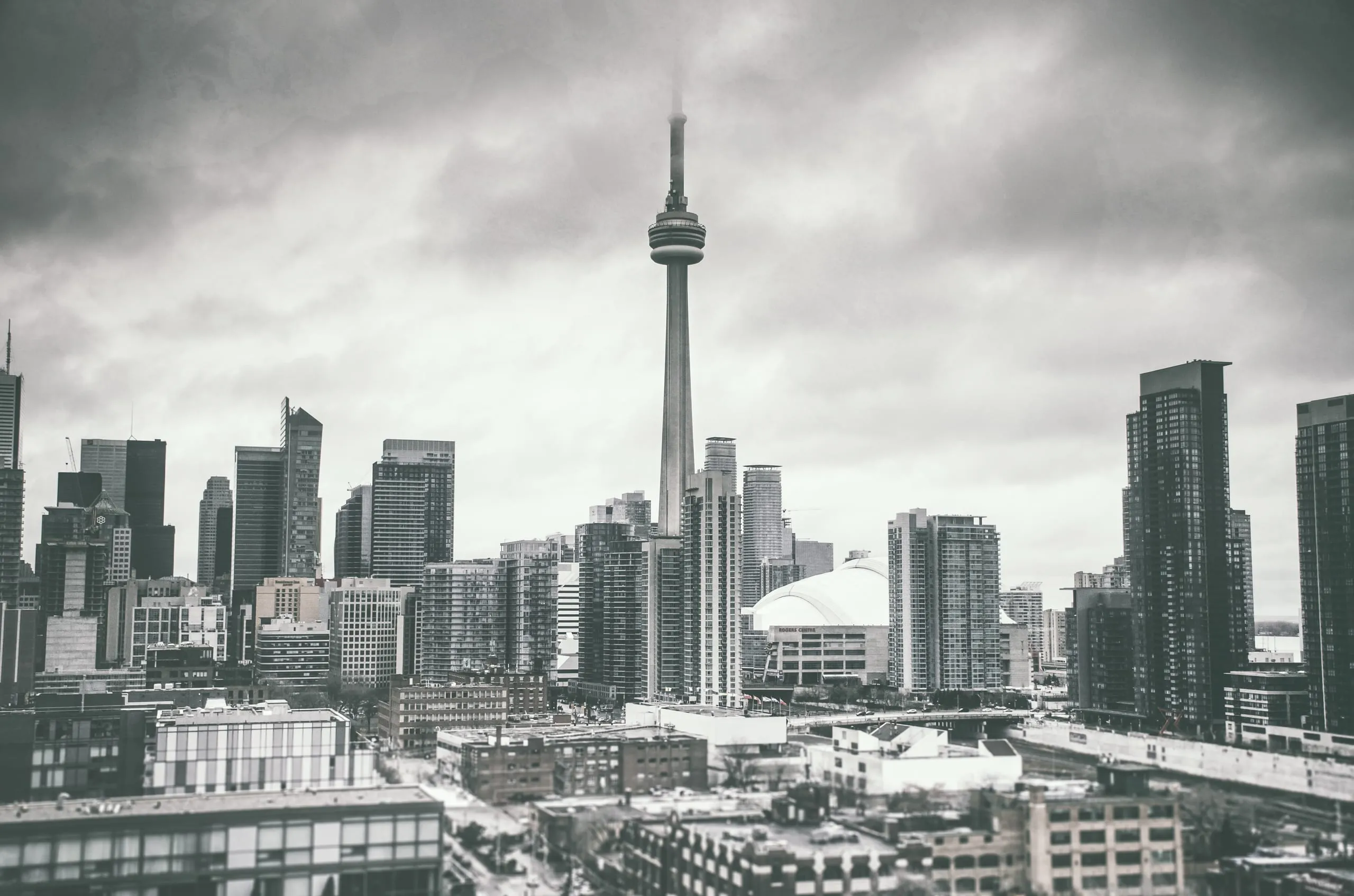 Toronto skyline with the CN Tower under dramatic storm light from the water
