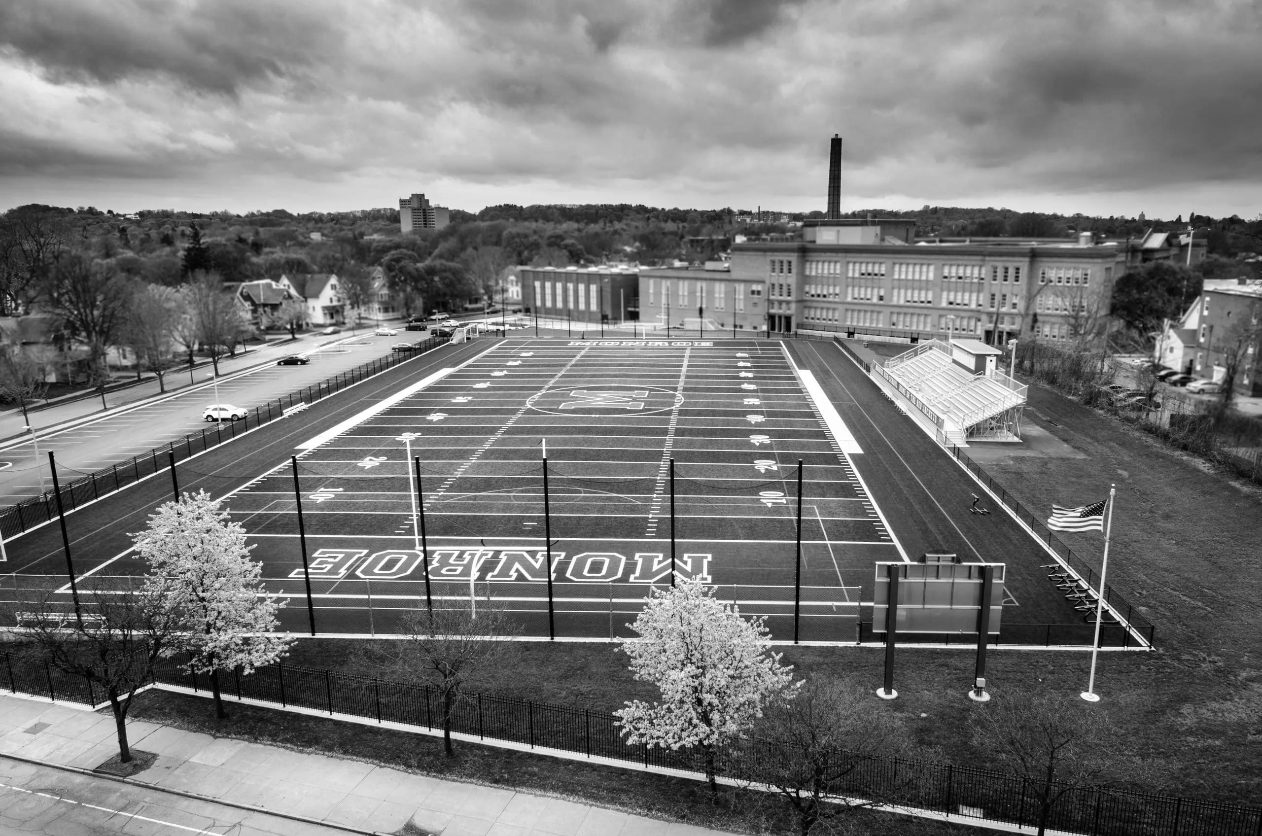 Black and white aerial graphic of an empty football field, Rochester