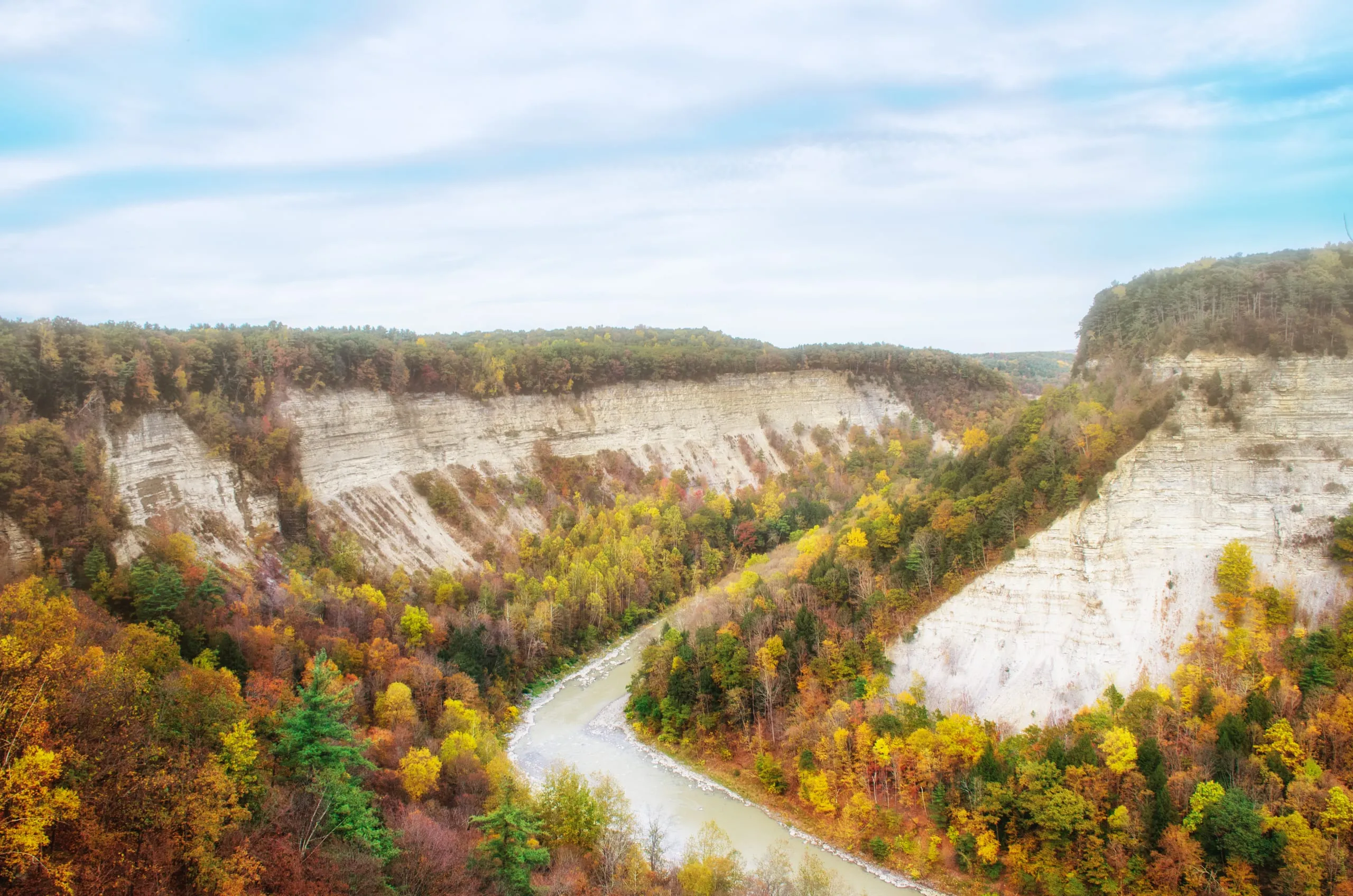 Aerial view of the Genesee River winding through Letchworth gorge in peak autumn color