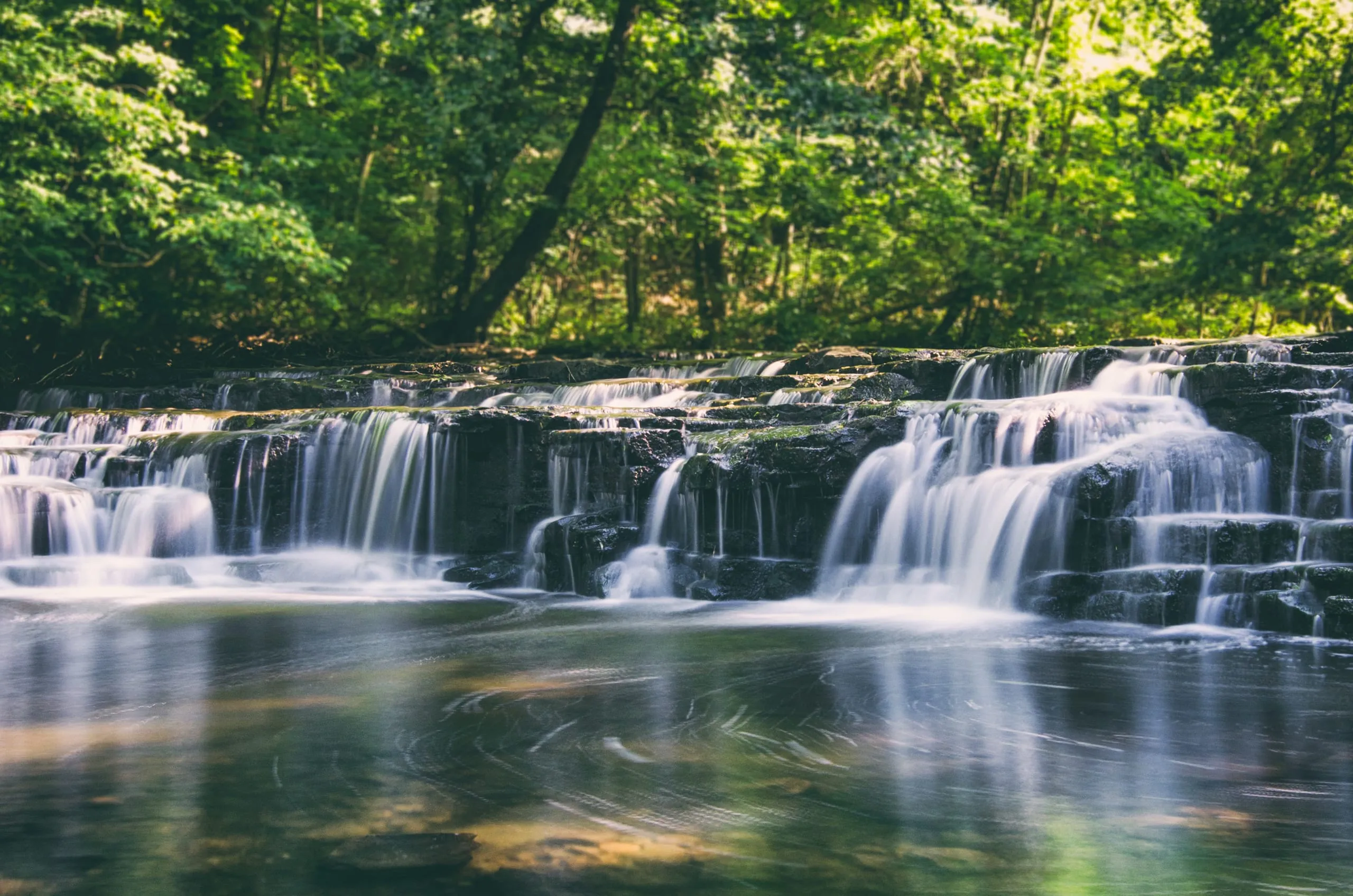 Long-exposure of a mossy tiered waterfall in Corbett's Glen near Rochester, New York