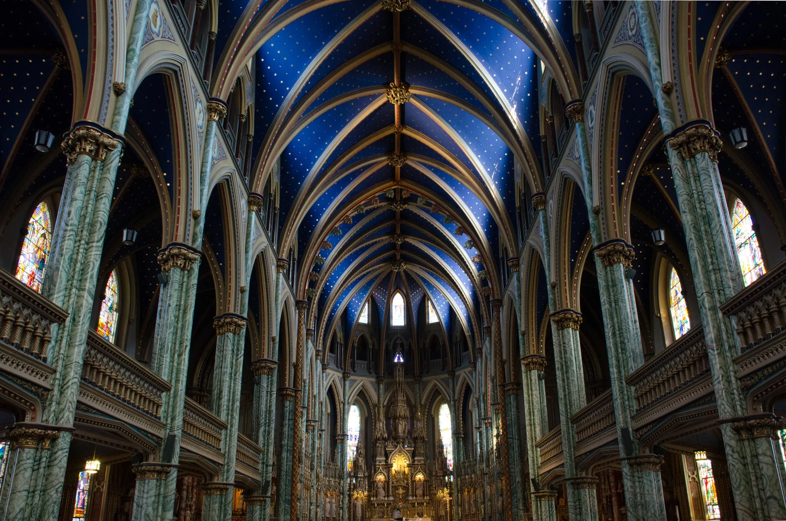 Symmetric nave of Notre-Dame Cathedral Basilica in Ottawa with starry blue vaulted ceiling