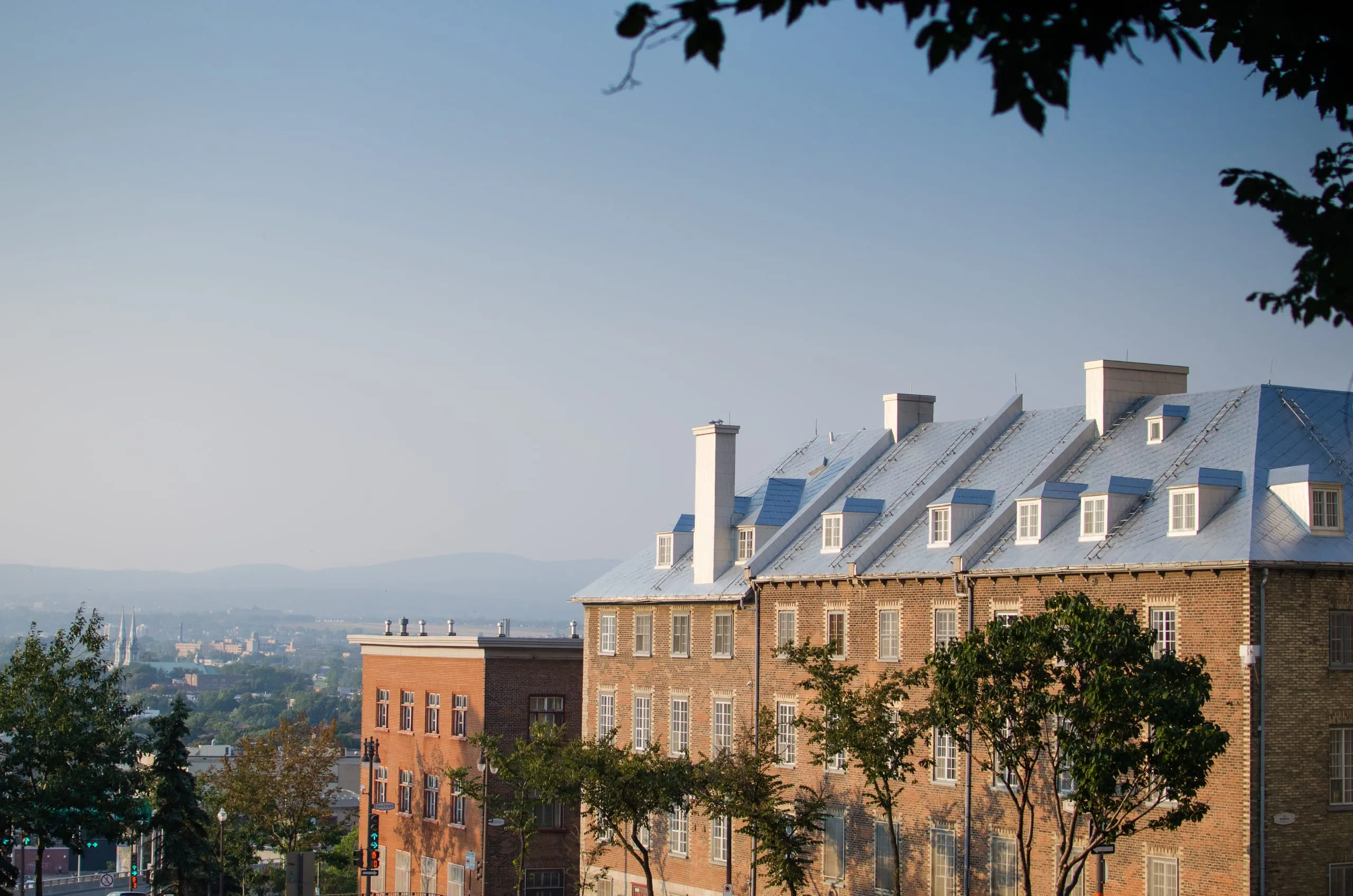 Steep metal rooftops of Old Québec at dusk