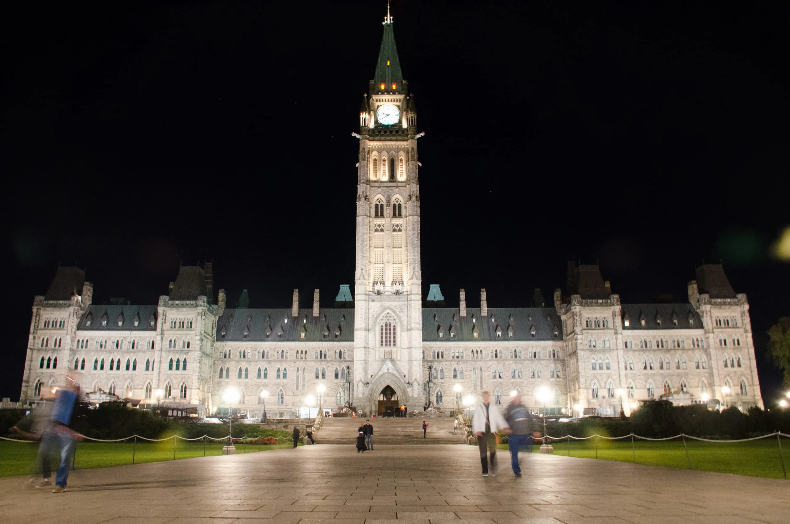 Parliament buildings washed in projected color during a night light show, Ottawa
