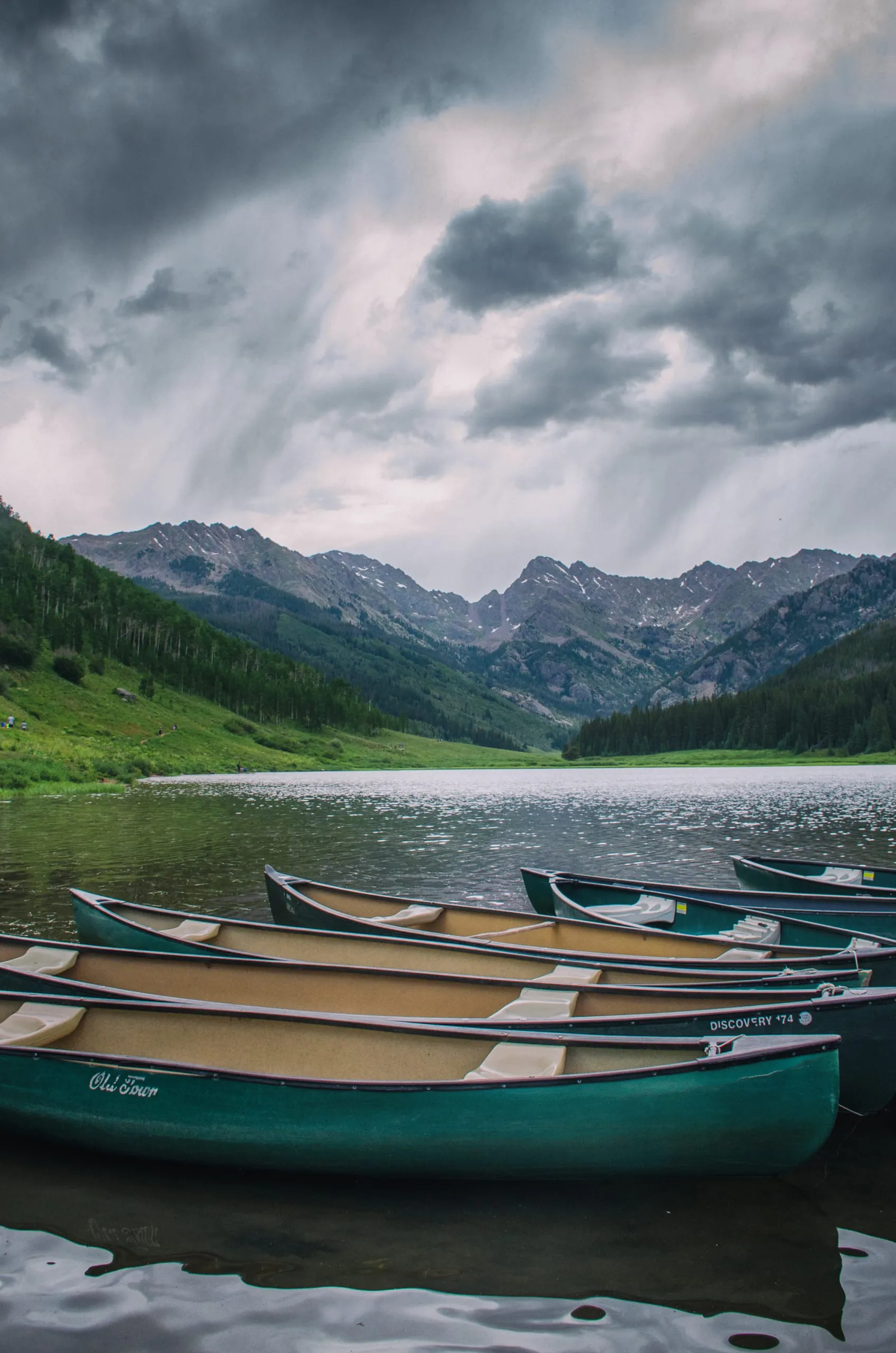 Canoes on Piney Lake under approaching storm light in Colorado