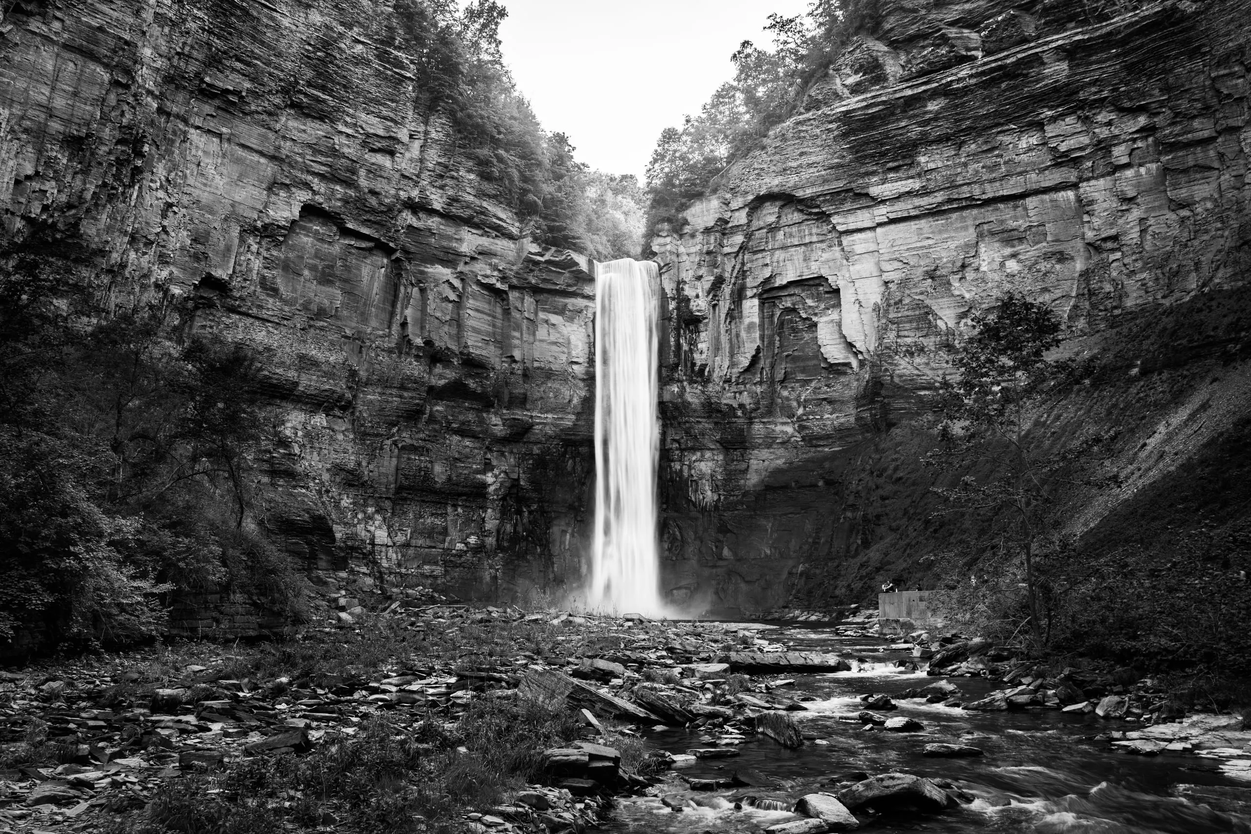 Black and white view of Taughannock Falls dropping into its vast rock amphitheater