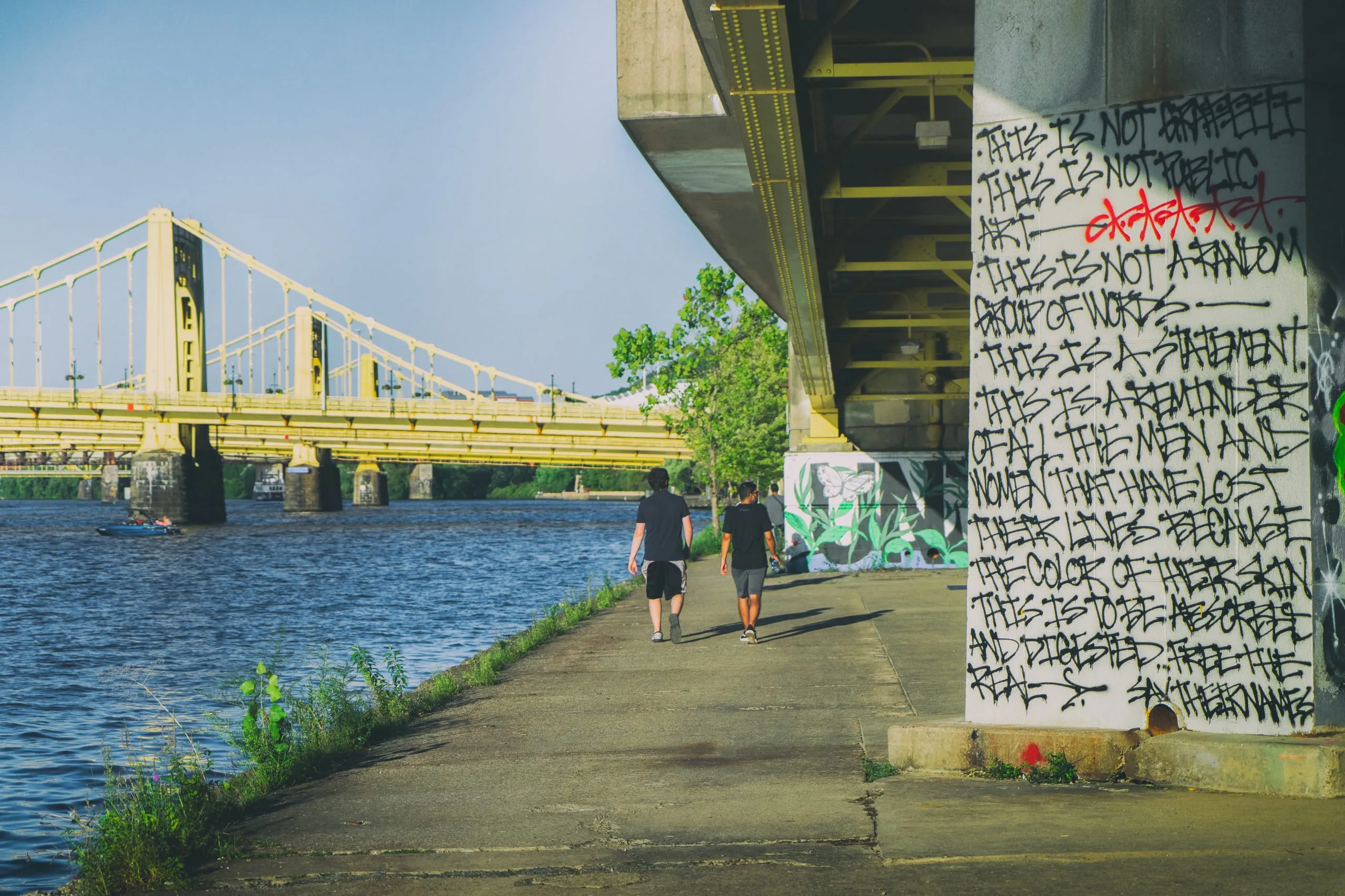 Graffiti-covered pillars beneath a bridge over the Allegheny River, Pittsburgh